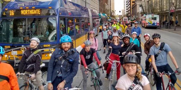 viaduct to tunnel bike ride participants alongside bus