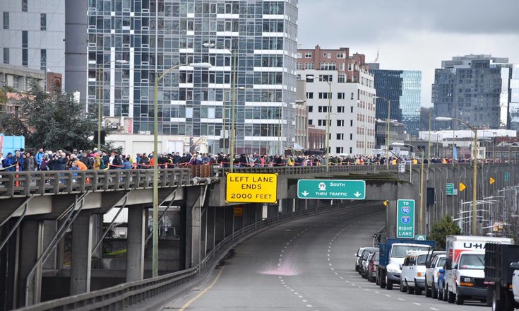 View of people on the viaduct for the grand opening with tunnel entrance looming below