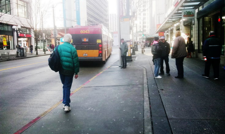 Riders approaching Rapid Ride on Third Ave