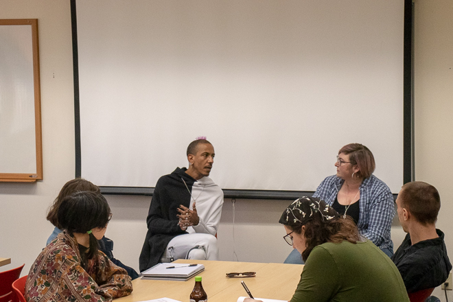 Left, Astro Pittman, Right, Tiffany-Ashton Gatsby - Sitting in front of group discussing LGBTQ issues