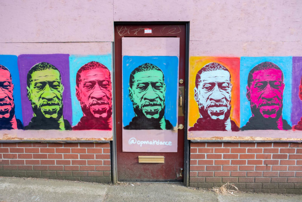  In the wake of George Floyd’s murder and subsequent protests, Seattle’s International District participated in a community-wide mural project, painting a variety of Black Lives Matter-themed artwork over the boarded up windows of many local businesses that were forced to close their doors due to theft and vandalism.