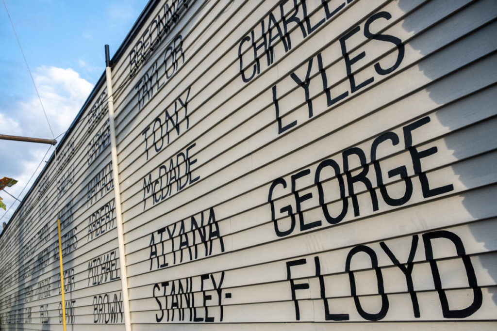 The names of victims of hate crime and police brutality span across the side of the Royal Room’s wall in Seattle’s Columbia City.