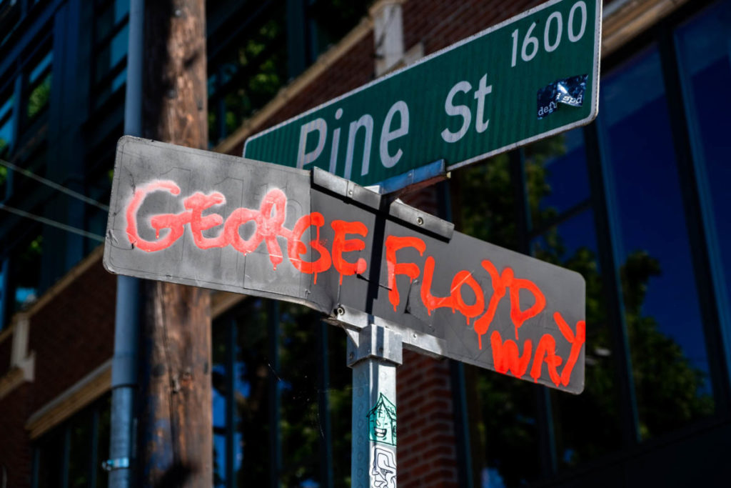 After the formation of CHAZ, protestors painted “George Floyd Way” over the 11th Avenue street sign.  11th Avenue and Pine Street became the epicenter of Seattle protests before the Seattle Police Department abandoned the East Precinct and subsequent formation of CHAZ.